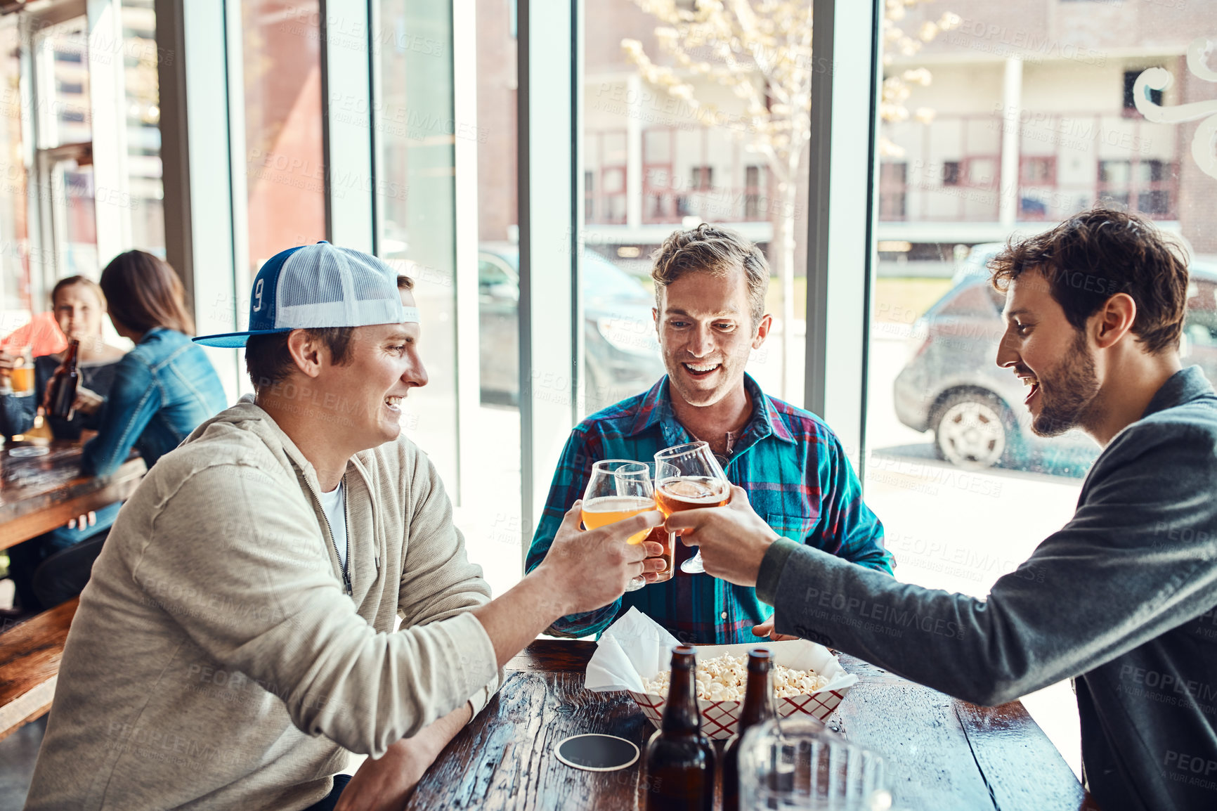 Buy stock photo Friends, men and toast in pub for beer with laugh for reunion, social gathering and date. Bar, people and smile with glass for drinking alcohol for fun, bonding and together with support and care