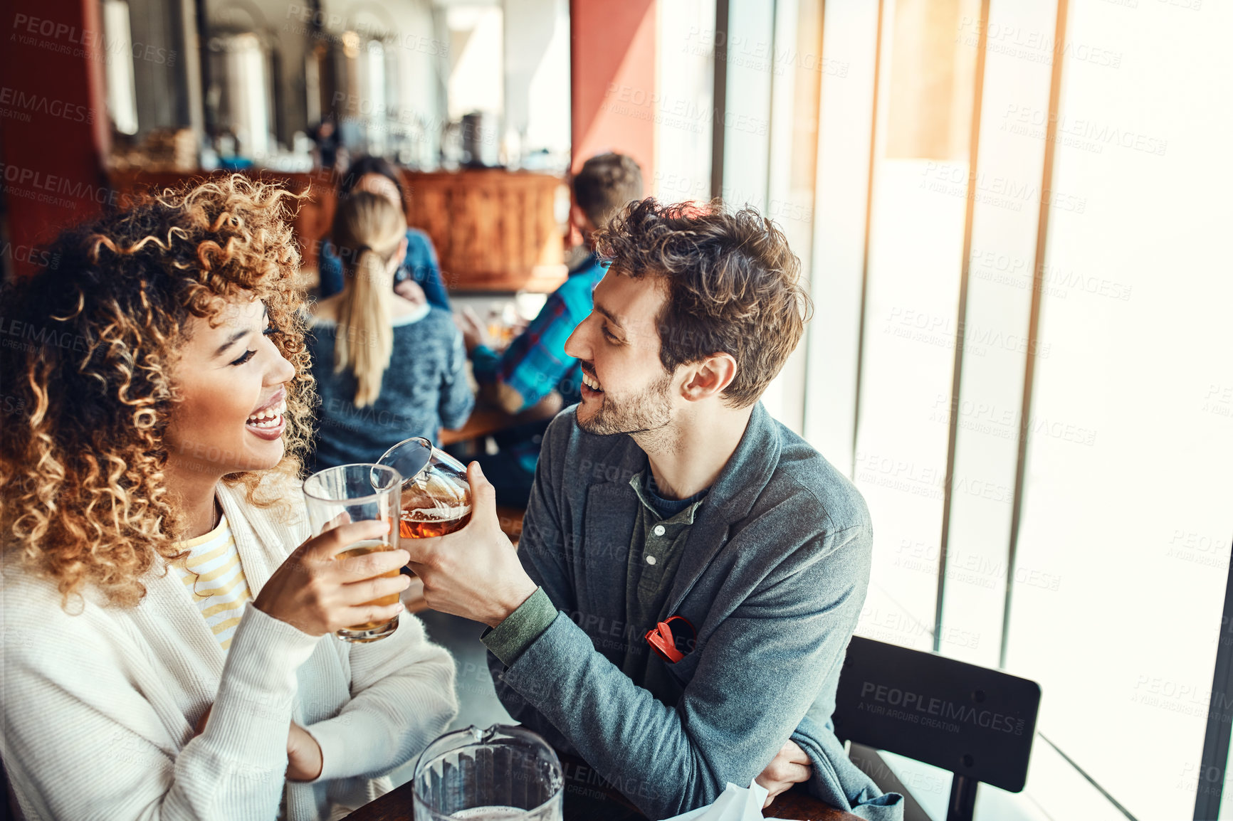 Buy stock photo Laugh, beer and toast with couple in pub for valentines day event, bonding and date. Happy hour celebration, alcohol drink and connection with man and woman at bar for cheers and restaurant diner