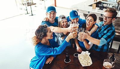 Buy stock photo Shot of a group of friends toasting with beers while watching a sports game at a bar