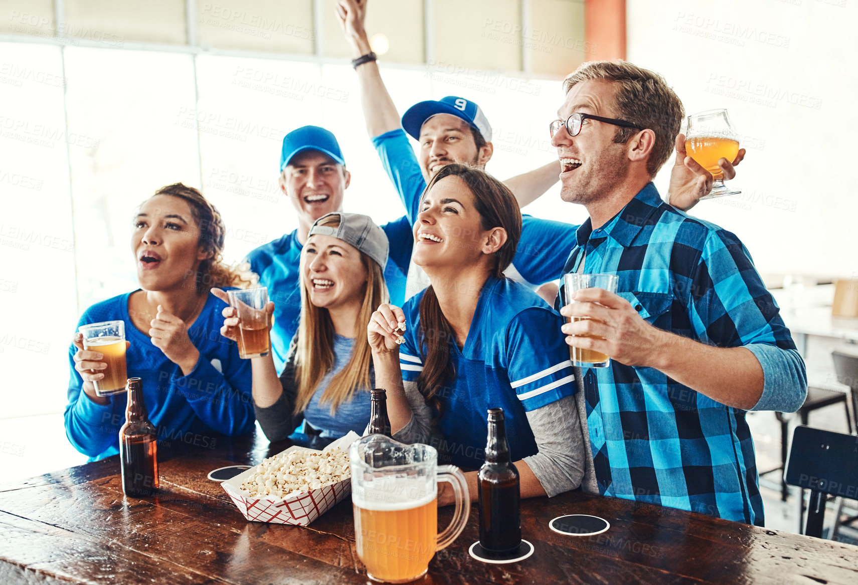 Buy stock photo Friends, celebration and watch football in pub with support, success and cheers for football match, game or sports. Group of people or fans with wow or excited for goal and happy hour drinks or beer