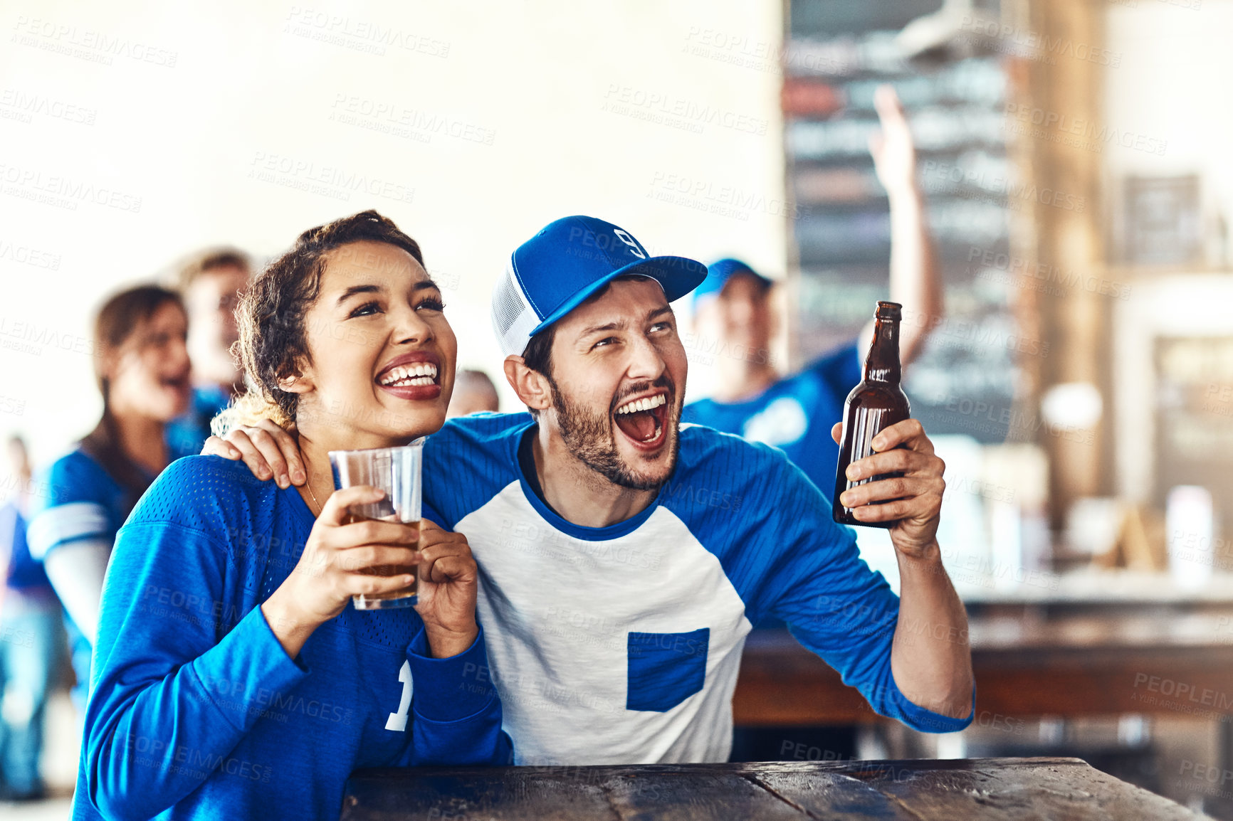 Buy stock photo Sports, excited or couple in pub with beer, smile or celebration of competition together. Support, soccer game or fun people hug in bar for watch party, alcohol drinks or fans at diner for happy hour