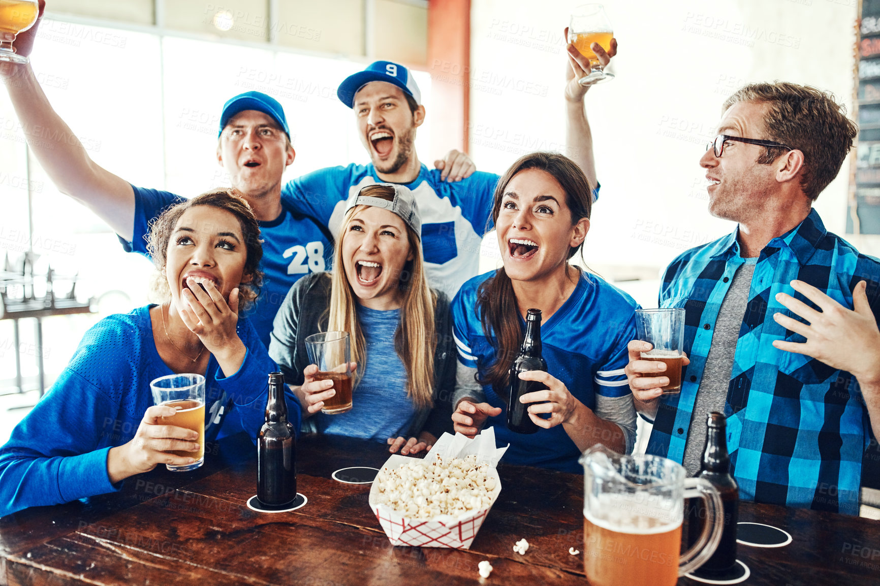 Buy stock photo Sports, celebration and happy people in pub with beer, tv and fans at broadcast of world cup together. Baseball, games and group of excited friends in bar for watch party, drinks and team support