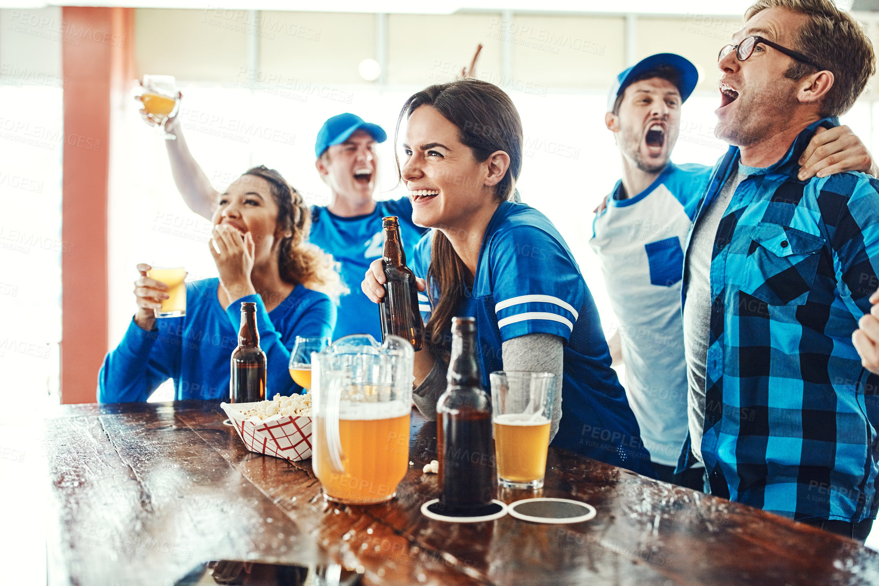 Buy stock photo Sports, celebration and people in pub with team solidarity, tv and fans with beer at broadcast of world cup. Baseball, games and group of excited friends in bar for watch party, drinks and support