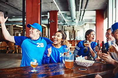 Buy stock photo Shot of a group of friends watching their favorite team live in a sports bar