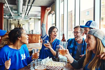 Buy stock photo Shot of a group of friends watching their favorite team live in a sports bar