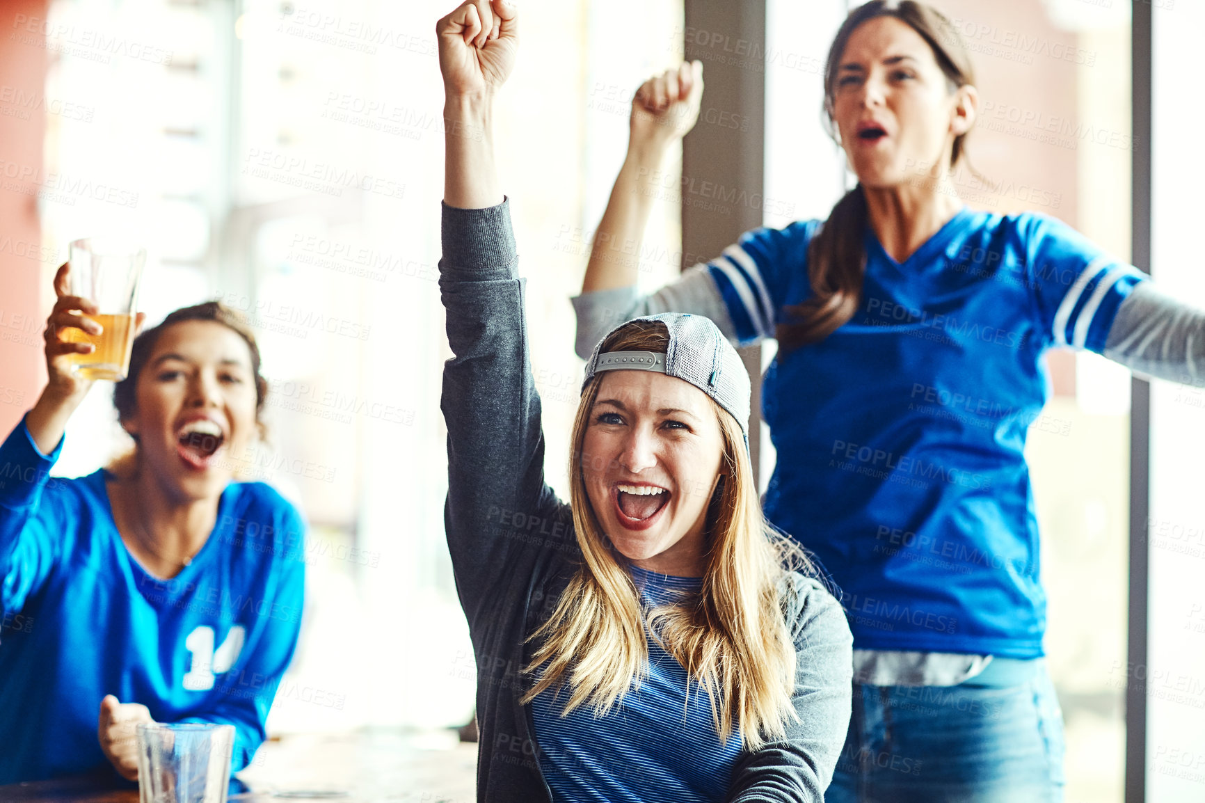 Buy stock photo Shot of three excited friends cheering on their favorite team