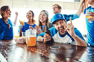 Buy stock photo Shot of people watching their favorite team live in a sports bar