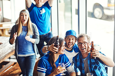 Buy stock photo A group of excited friends cheering on their favourite team at the bar