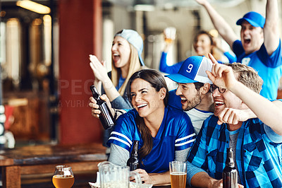 Buy stock photo A group of excited friends cheering on their favourite team at the bar