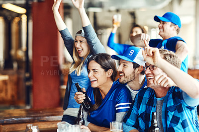 Buy stock photo A group of excited friends cheering on their favourite team at the bar