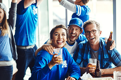 Buy stock photo A group of excited friends cheering on their favourite team at the bar