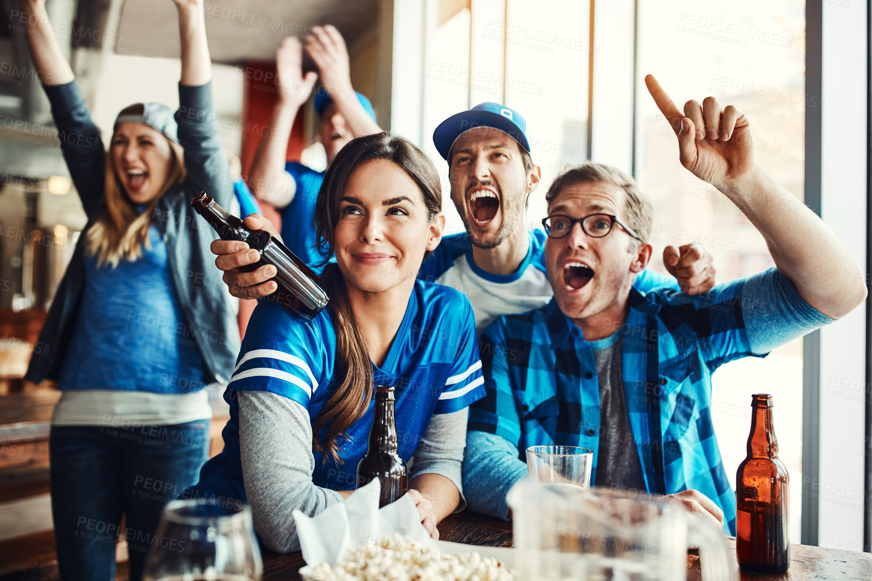 Buy stock photo Friends, smile and sports game success, tournament victory and celebration of football league match event. Men, woman and team support, fan and winning with beer of score achievement at pub
