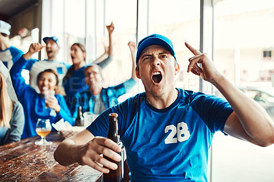 Buy stock photo Shot of a man holding up one finger while watching a sports game with friends at a bar