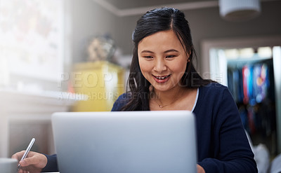 Buy stock photo Cropped shot of an attractive young female entrepreneur working on her laptop at home