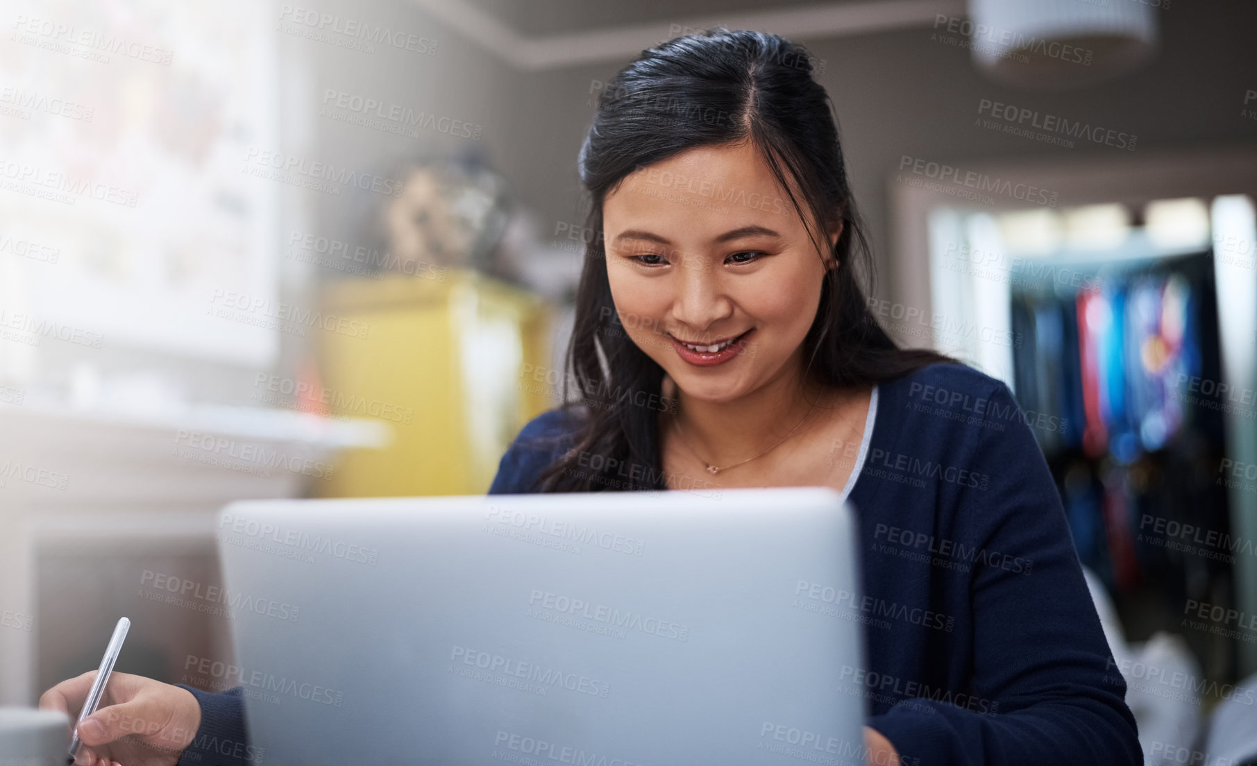 Buy stock photo Cropped shot of an attractive young female entrepreneur working on her laptop at home