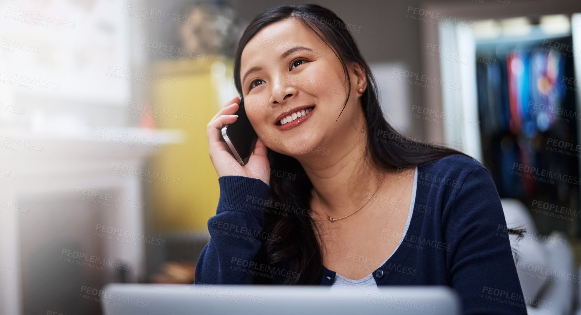 Buy stock photo Cropped shot of an attractive young female entrepreneur making a call while working from home