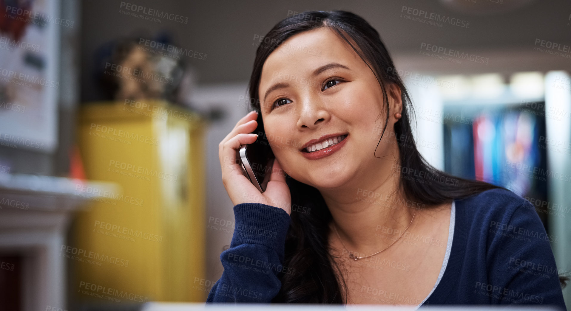 Buy stock photo Cropped shot of an attractive young female entrepreneur making a call while working from home