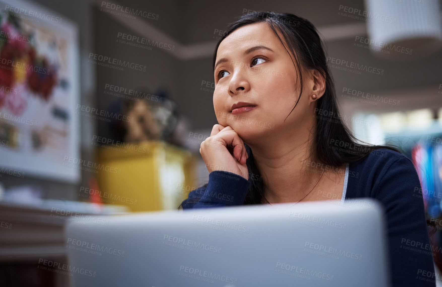 Buy stock photo Cropped shot of an attractive young female entrepreneur looking thoughtful while working from home