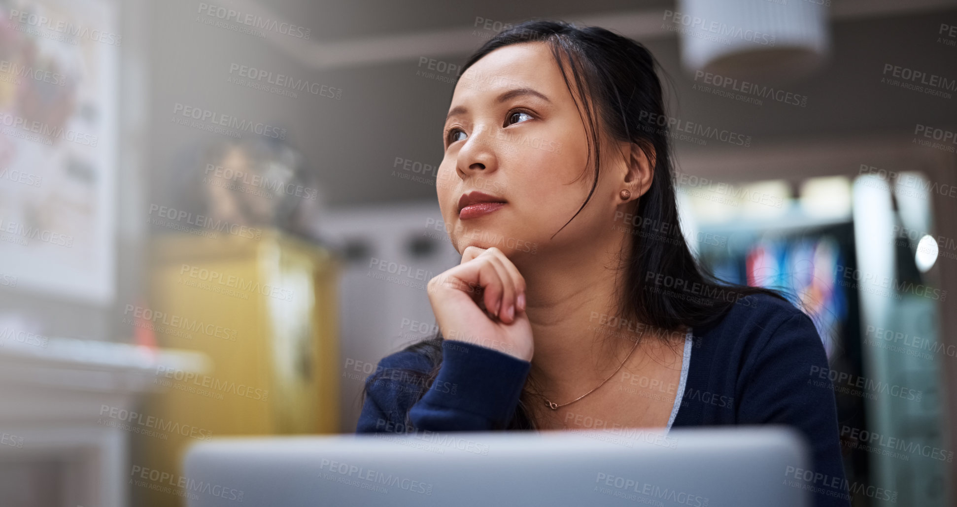 Buy stock photo Cropped shot of an attractive young female entrepreneur looking thoughtful while working from home