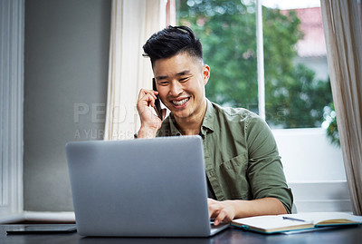 Buy stock photo Cropped shot of a handsome young man taking a call while working at home