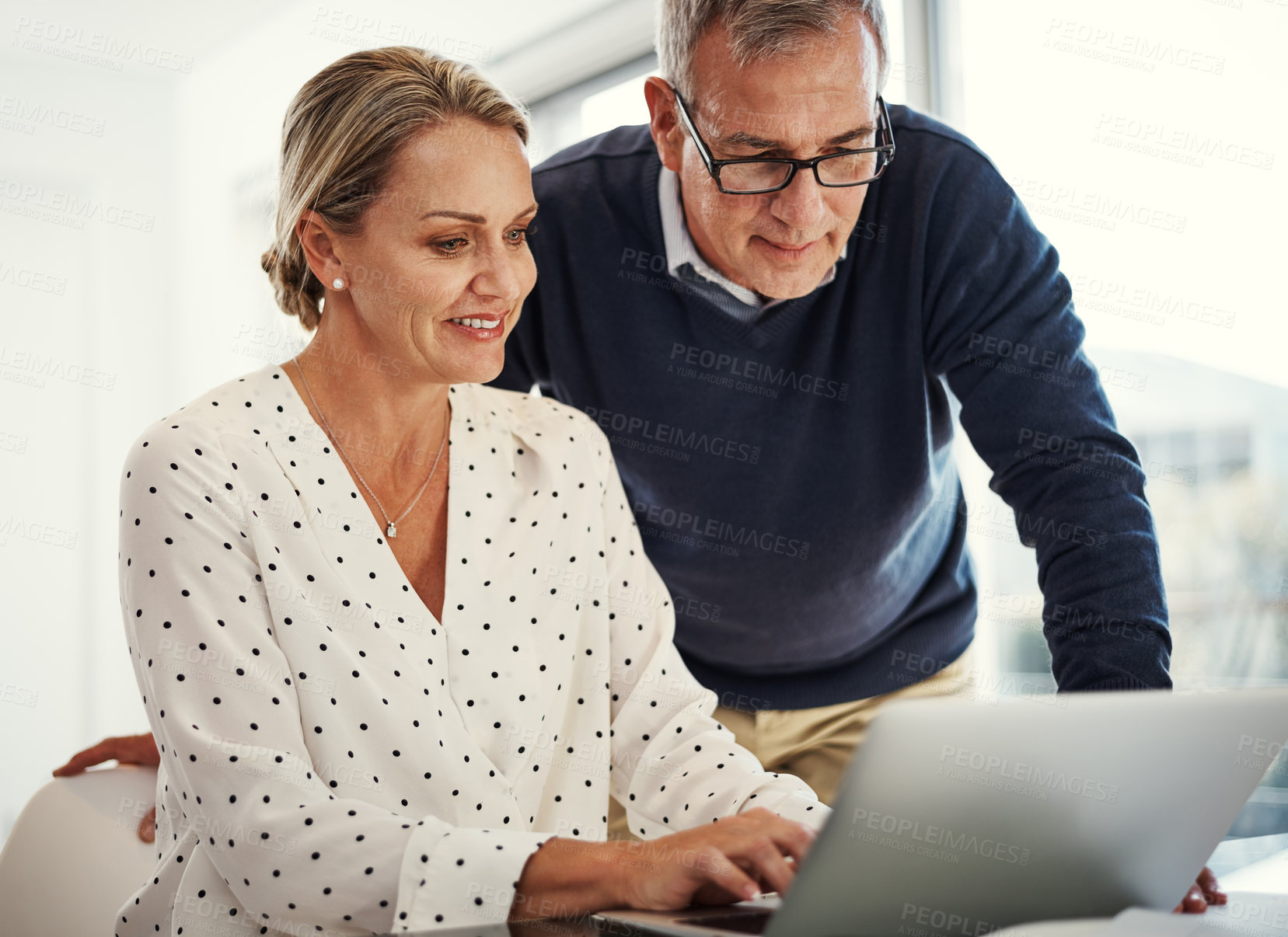 Buy stock photo Shot of a mature couple using a laptop together at home