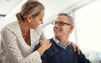 Buy stock photo Shot of a happy mature couple spending time together at home