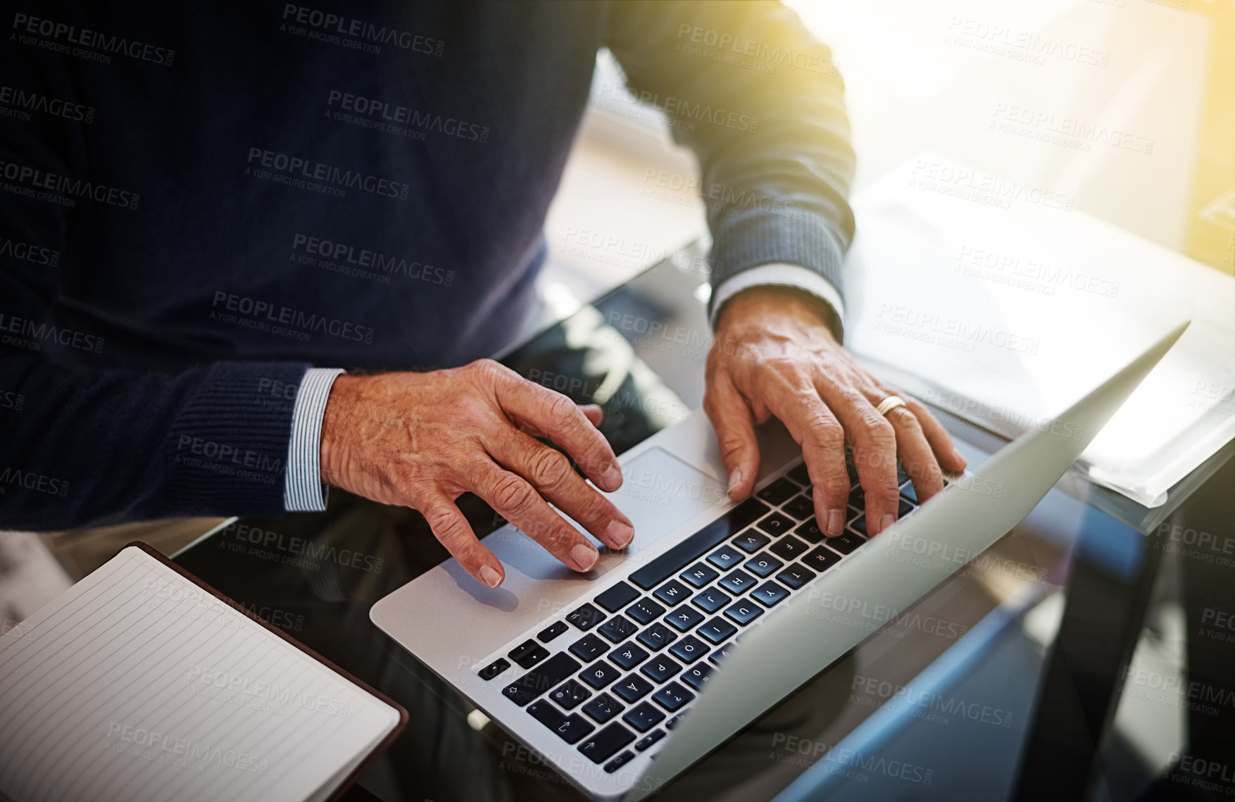 Buy stock photo Cropped shot of a businessman using a laptop at his work desk