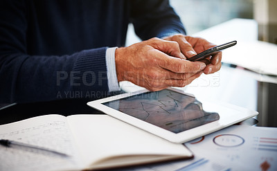 Buy stock photo Cropped shot of a businessman using a mobile phone at his work desk