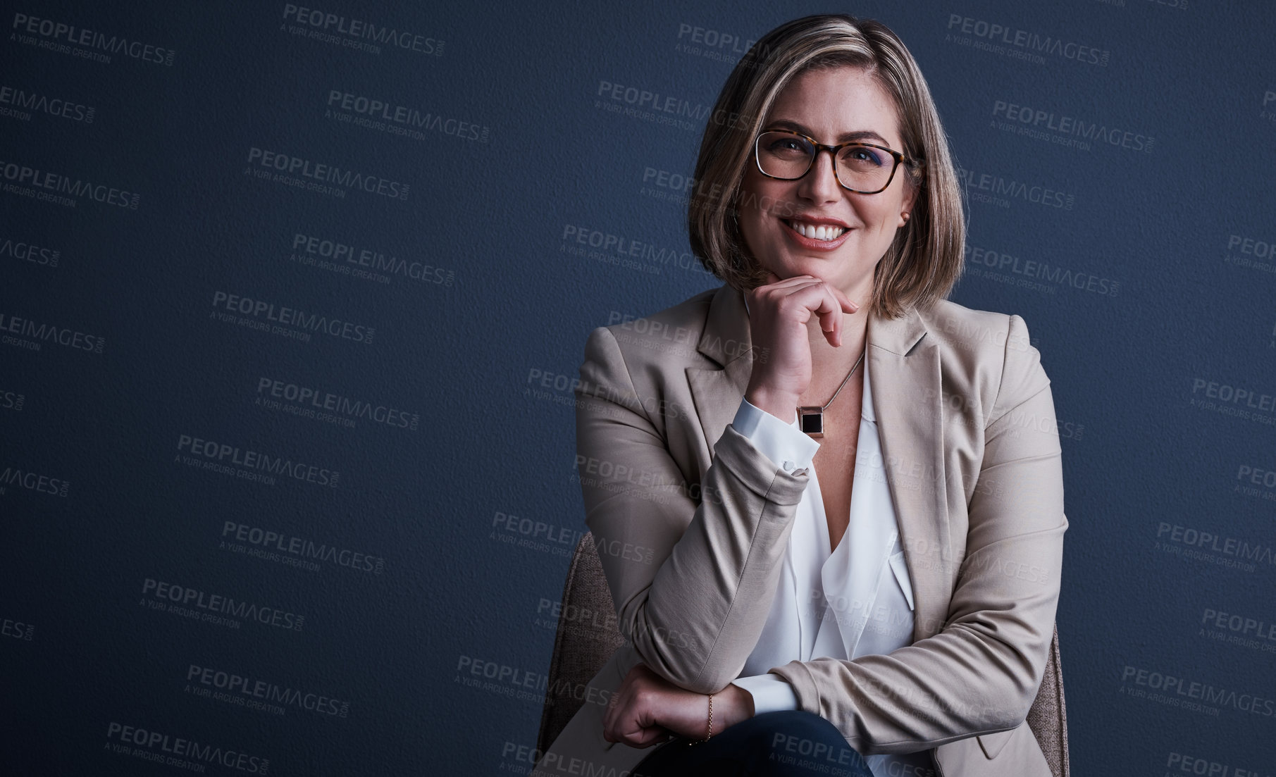 Buy stock photo Studio portrait of an attractive young corporate businesswoman posing against a dark background