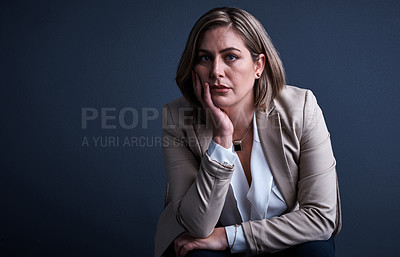 Buy stock photo Studio portrait of a young corporate businesswoman looking stressed against a dark background