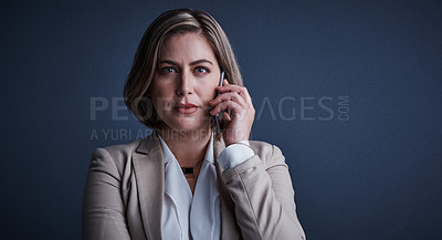 Buy stock photo Studio portrait of an attractive young corporate businesswoman making a call against a dark background