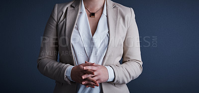 Buy stock photo Studio shot of an unrecognizable corporate businesswoman posing against a dark background