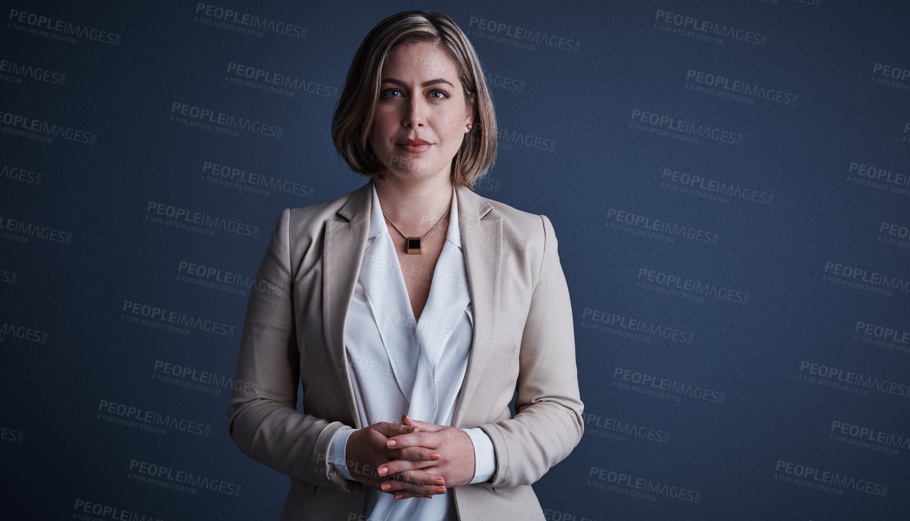 Buy stock photo Studio portrait of an attractive young corporate businesswoman posing against a dark background