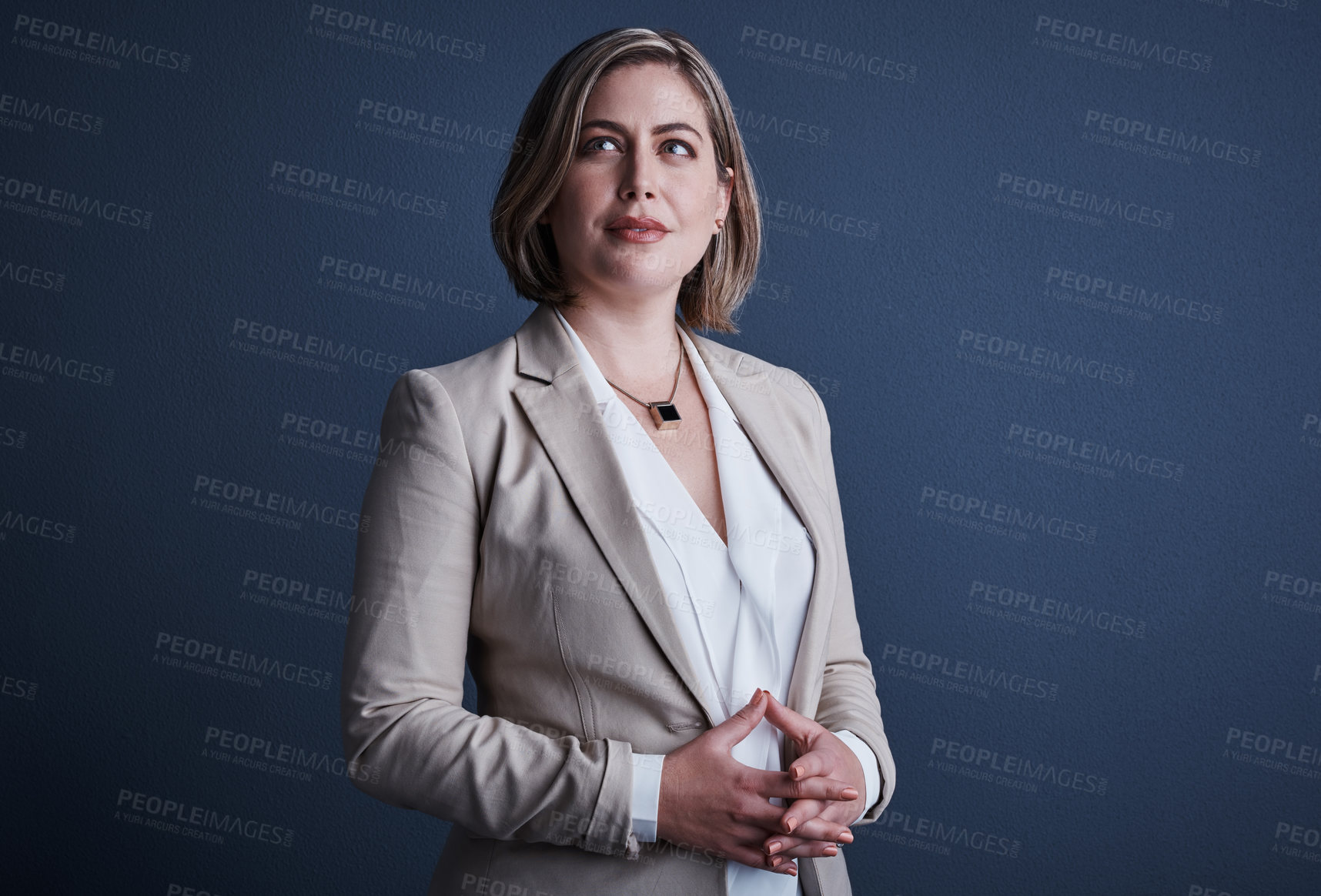 Buy stock photo Studio shot of an attractive young corporate businesswoman posing against a dark background