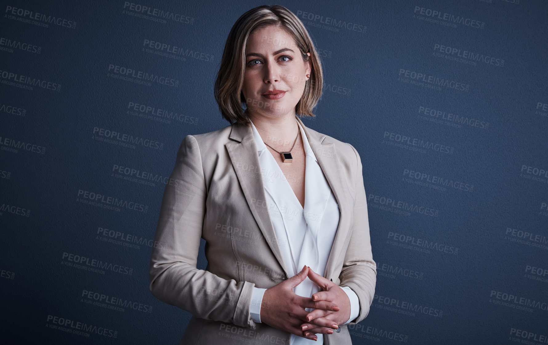 Buy stock photo Studio portrait of an attractive young corporate businesswoman posing against a dark background