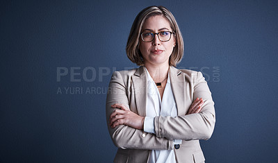 Buy stock photo Studio portrait of an attractive young corporate businesswoman posing against a dark background