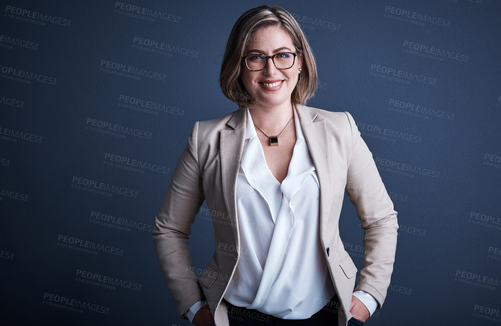 Buy stock photo Studio portrait of an attractive young corporate businesswoman posing against a dark background