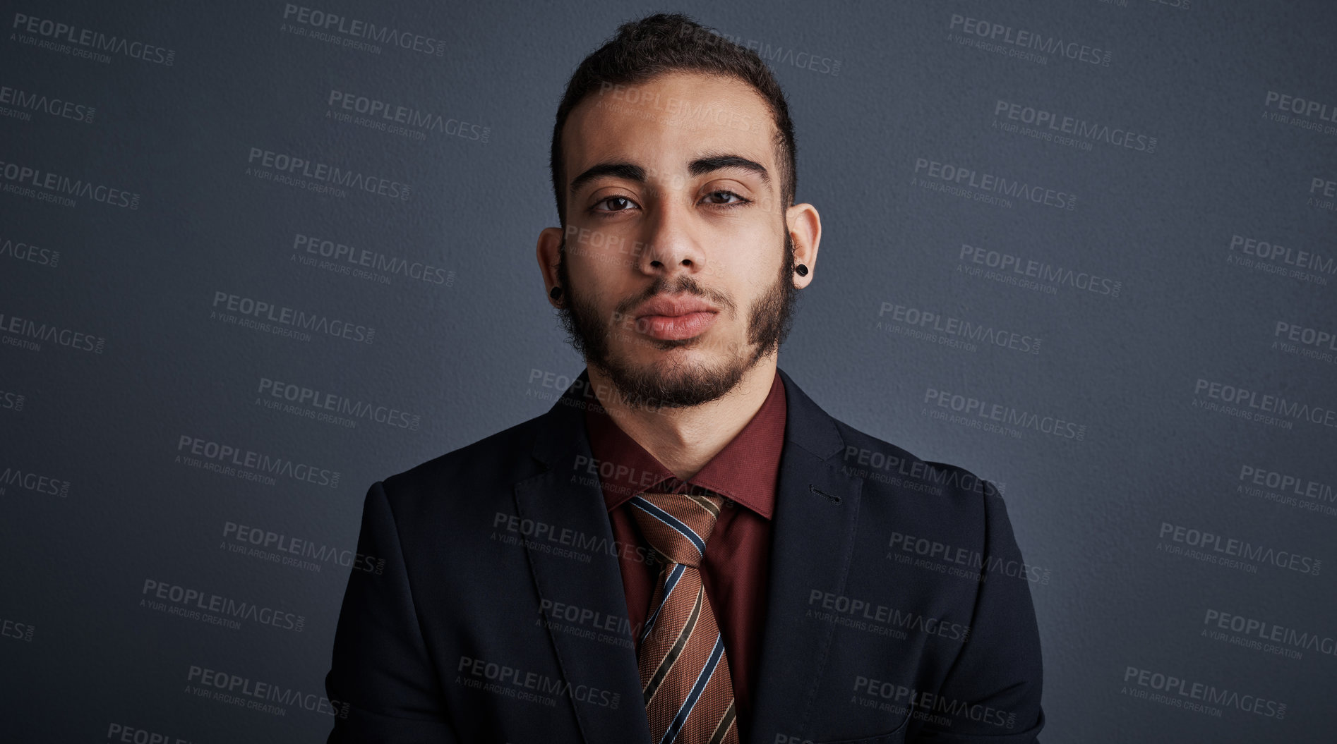 Buy stock photo Studio portrait of a stylish young businessman against a gray background