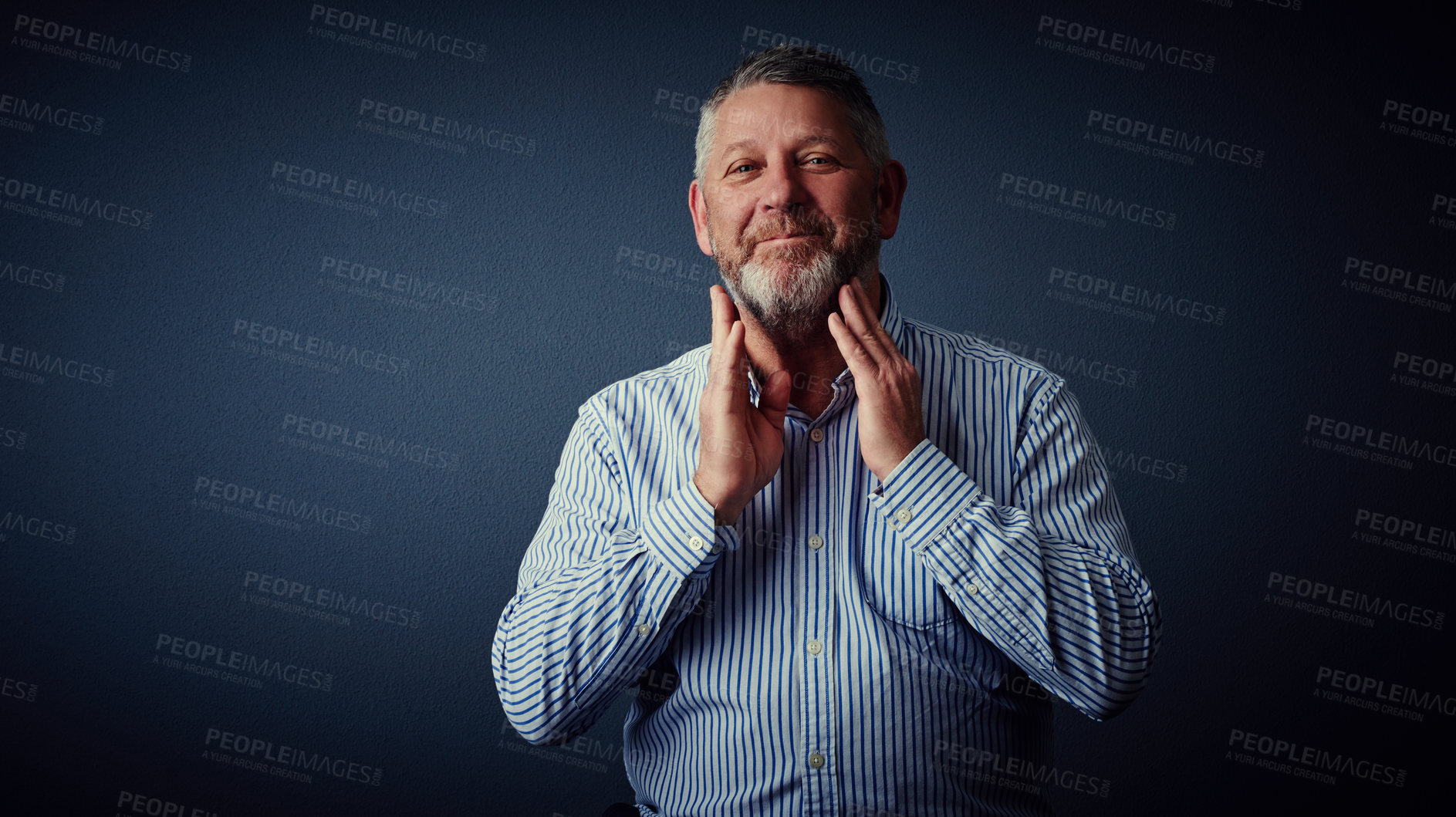 Buy stock photo Studio portrait of a mature businessman posing against a dark background