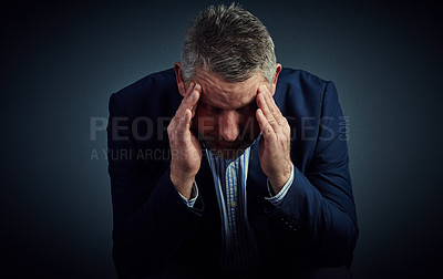 Buy stock photo Studio shot of a mature businessman posing against a dark background 