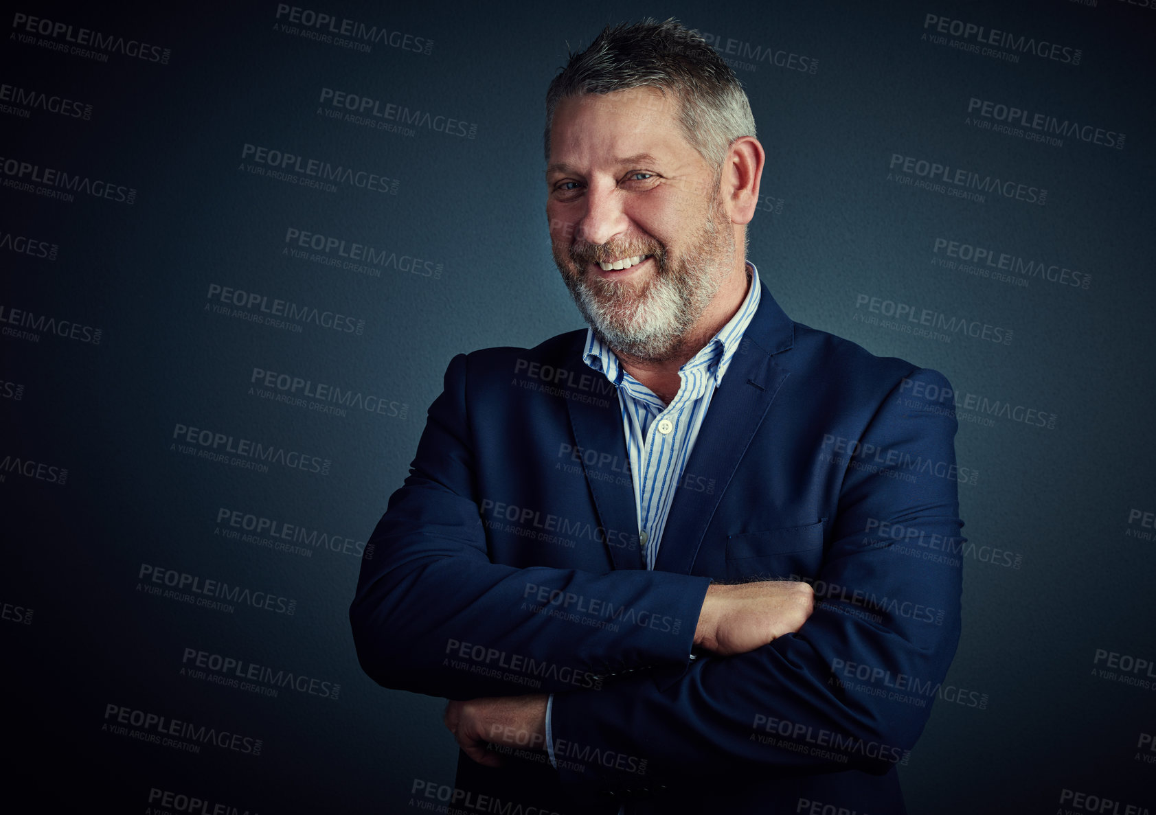 Buy stock photo Studio portrait of a confident and mature businessman standing with his arms folded against a dark background