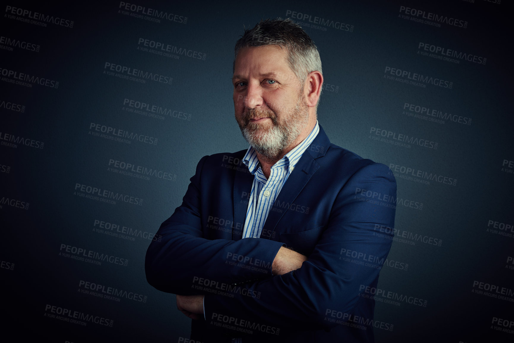 Buy stock photo Studio portrait of a confident and mature businessman standing with his arms folded against a dark background