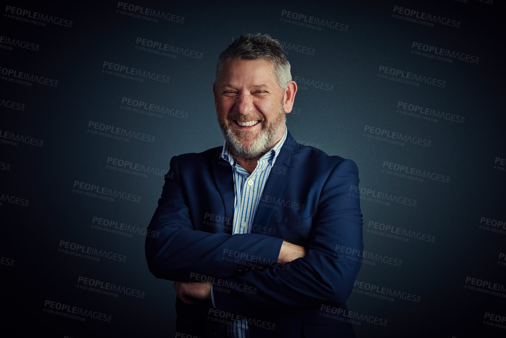 Buy stock photo Studio portrait of a confident and mature businessman standing with his arms folded against a dark background