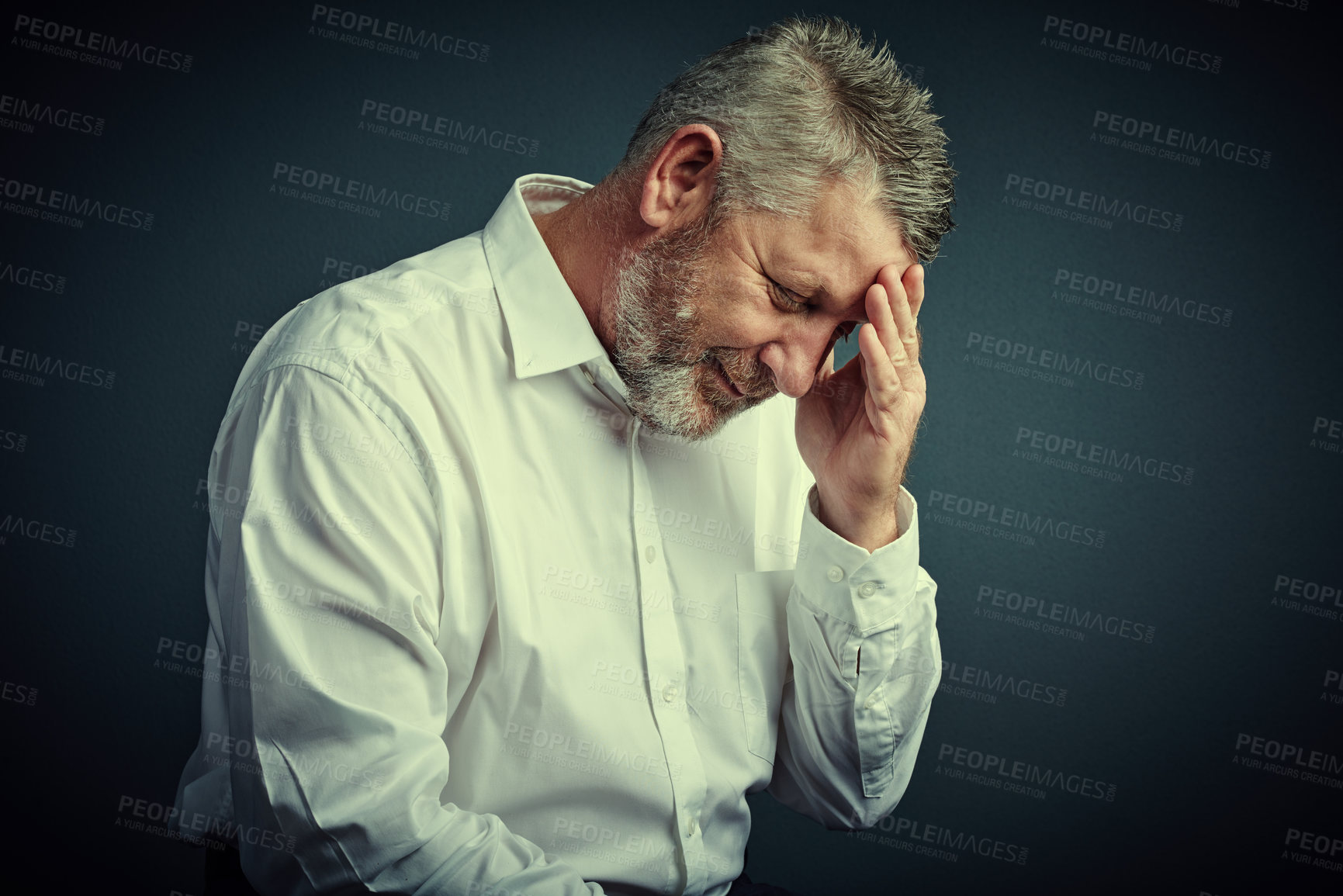 Buy stock photo Studio shot of a mature businessman looking stressed while sitting down against a dark background
