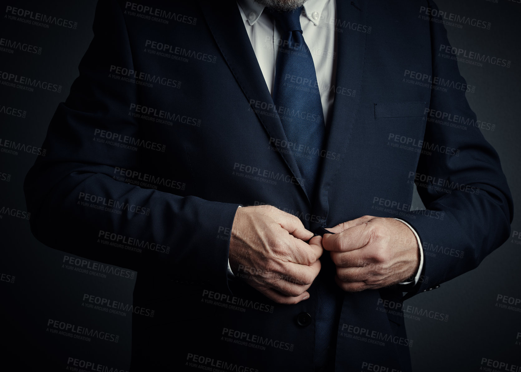 Buy stock photo Studio shot of an unrecognizable mature businessman buttoning his jacket while standing against a dark background