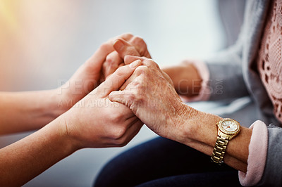 Buy stock photo Cropped shot of an unrecognizable female nurse holding her senior patient's hand in comfort