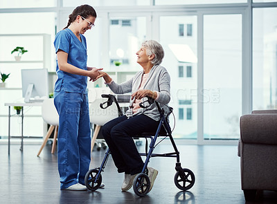 Buy stock photo Full length shot of a young female nurse talking to her senior patient in the old age home