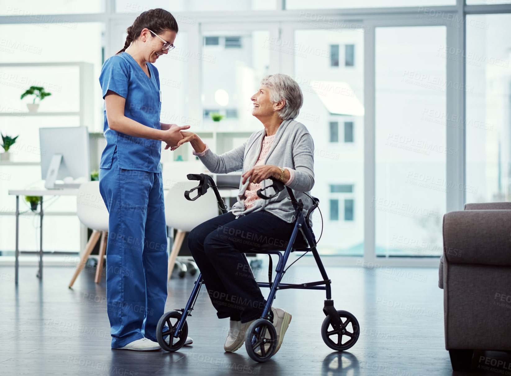 Buy stock photo Full length shot of a young female nurse talking to her senior patient in the old age home