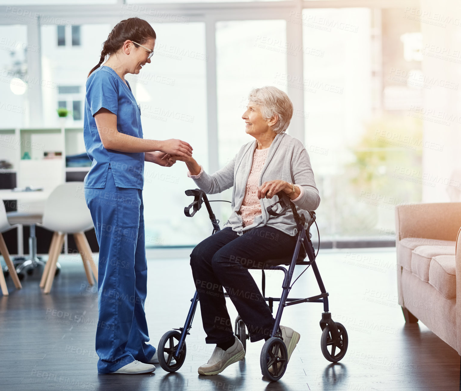 Buy stock photo Full length shot of a young female nurse talking to her senior patient in the old age home