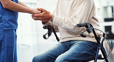 Buy stock photo Cropped shot of an unrecognizable female nurse holding her senior patient's hand in comfort